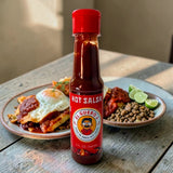El Guero 2 hot salsa with chilaquiles topped with a fried egg and limes, a Mexican breakfast hot sauce